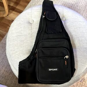 Sport - Black Canvas Sling Bag with plenty of compartments. gently used.